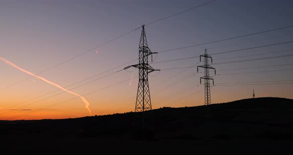 Columns High Voltage High Power Sunlight in the Moravia Tuscany region. Colorful sky in backgroud. alt