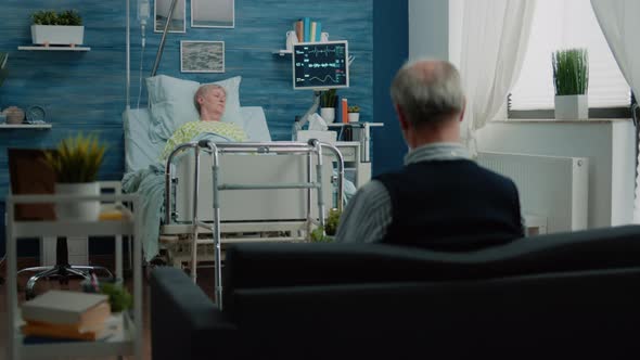 Sick Retired Woman Resting in Hospital Bed After Surgery alt