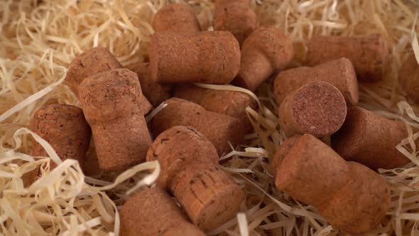 Champagne wine corks fall on the straw. Slow motion. alt