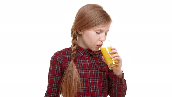 Cute Smiling Elementaryschool Aged Girl with Plait of Hair Drinking Tasty Orange Juice with Great alt