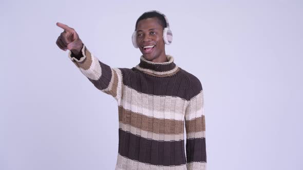 Young Happy African Man Pointing Finger Ready for Winter alt