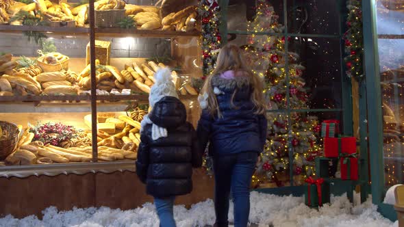 Girls Examining Bread in Bakery Window on Christmas Day