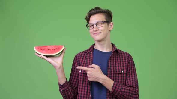 Young Handsome Teenage Nerd Boy with Slice of Watermelon alt