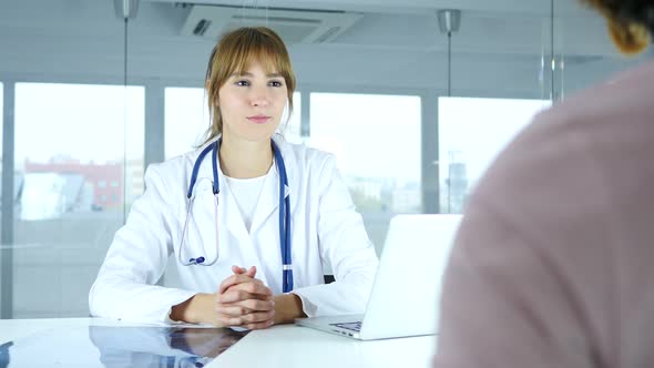 Lady Doctor Talking with Patient in Clinic alt