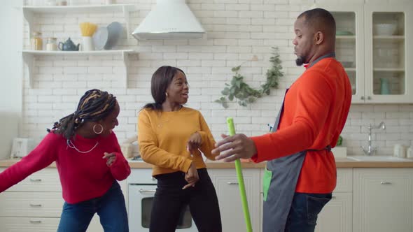 Portrait of Excited Black Family Having Fun During Cleanup alt