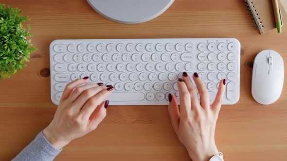 Woman typing on computer keyboard