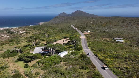 Flight above rural African highway with distant view of Cape of good hope; drone alt