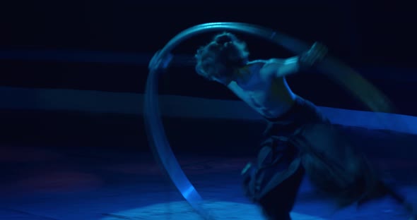 Difficult Tricks Performed By a Young Wheel Gymnast on Stage of a Circus alt