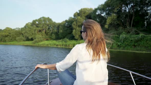 Beautiful Woman Sitting On Front Deck Of Boat