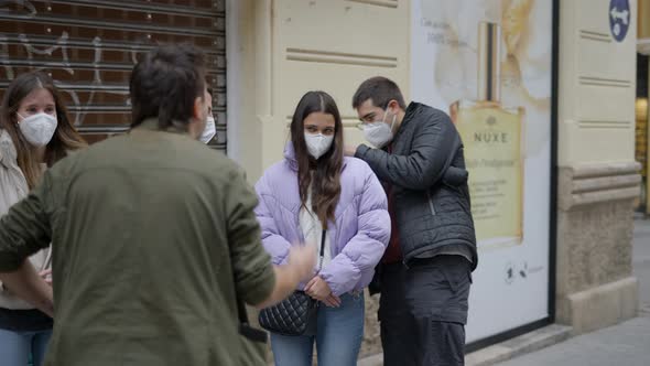Back View of Magician Showing Magic Tricks to Unknown Person in the Street alt