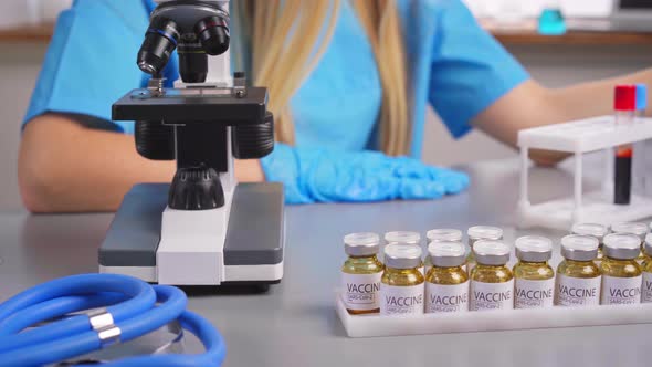 Woman Laboratory Researcher Working with Blood Samples Test Tubes alt