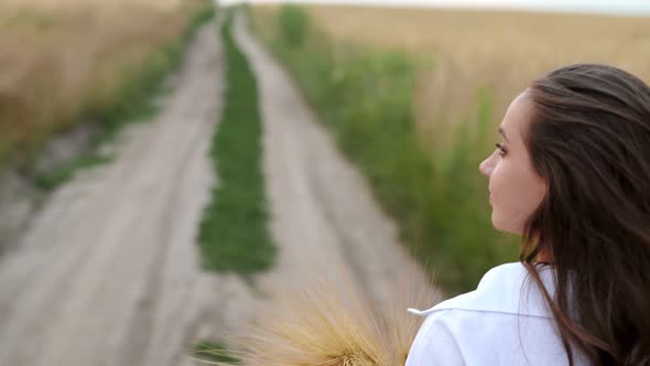 Young Woman Touching Wheat Ears at Sunrise Dolly Shot SLOW MOTION Happy Girl Running Her Hand