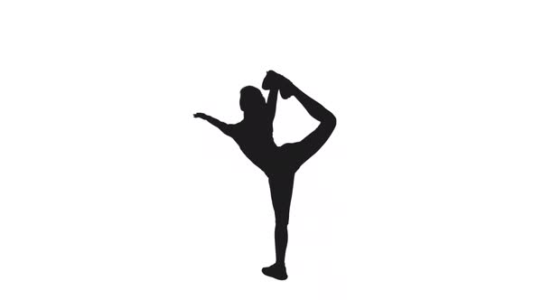 Silhouette Of Young Slender Woman Doing Stretching Exercises