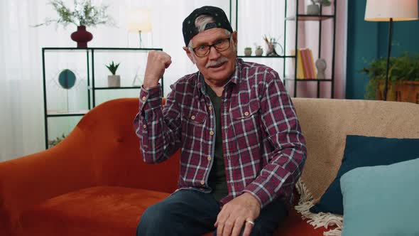 Grandfather Man Shouting Raising Fists in Gesture I Did It Celebrating Success Winning at Home alt