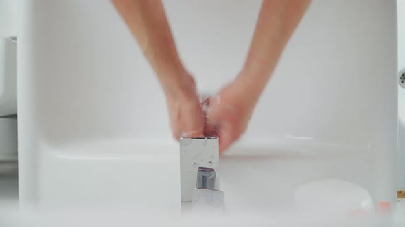 Female Hands Washing In Basin. Hygiene during coronavirus. A woman washes her hands alt