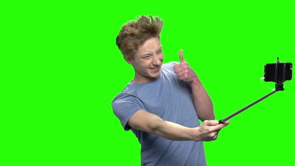 Teenage Boy Taking Selfie Picture with Mobile Phone alt