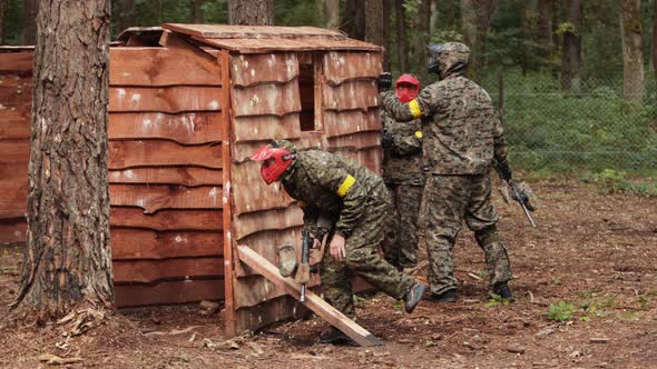 Paintball Sport Player Wearing Protective Mask Aiming Gun Shelter Under Attack alt