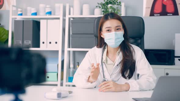 Asian medical woman doctor record video online for patient in hospital. alt