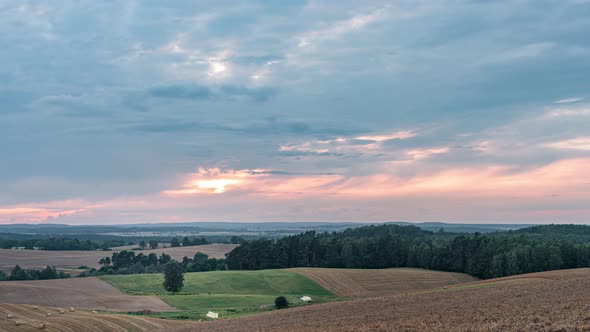 Sunset Over Rural Fields and Forests in a Countryside Timelapse