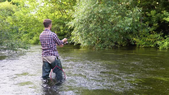 Fisherman with Fishing Rod on the River alt