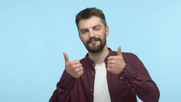 Happy Young Bearded Man Praising Good Promotion Dancing with Thumbs Up and Smiling Pleased Recommend