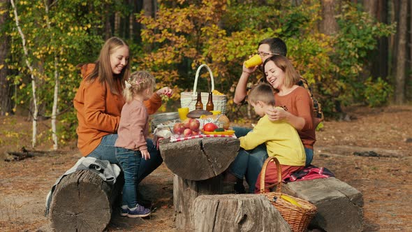 Family on a Picnic at a Resting Place in a Pine Forest alt
