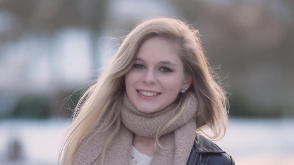Young blond woman looking towards camera.