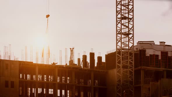 Crane Working on Construction Site Elevate Steel Weight, Constructors Working Sunny Evening alt