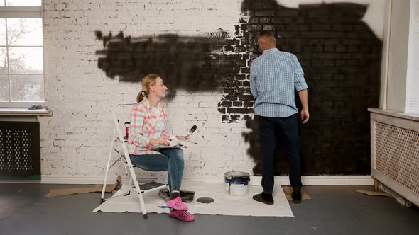 Caucasian Young and Cheerful Man and Woman Talking and Deciding How to Decorate a Room alt
