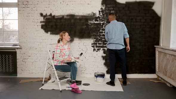 Caucasian Young and Cheerful Man and Woman Talking and Deciding How to Decorate a Room