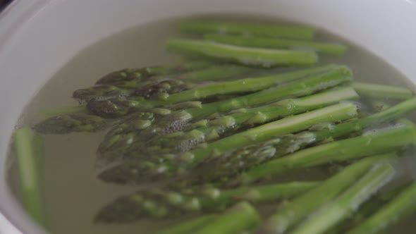 Delicious Green Asparagus Boiled in Salted Water in a Saucepan in the Kitchen