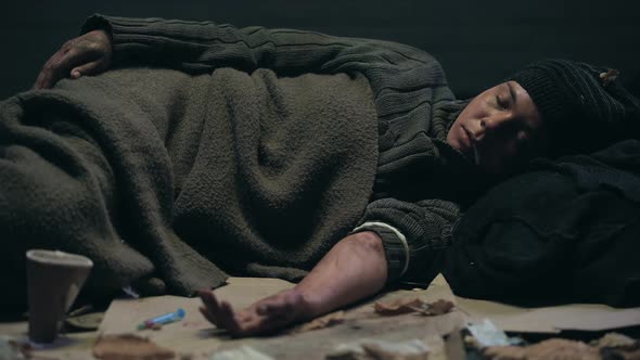 Drug Abused Homeless Sleeping on Dirty Street, Overdose Concept, Addiction alt