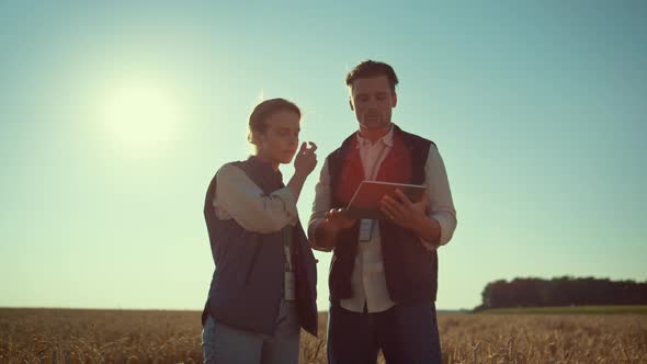 Agronomists Team Holding Tablet Computer in Sunlight alt