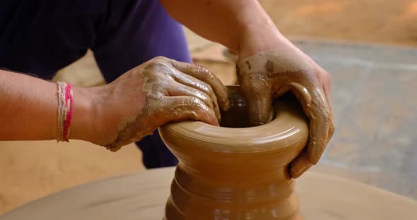Pottery - Skilled Wet Hands of Potter Shaping the Clay on Potter Wheel. Pot, Vase Throwing alt