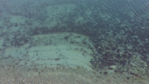 Transparent sea water. Layered rocky bottom of sedimentary rocks underwater. Geology of the seabed alt