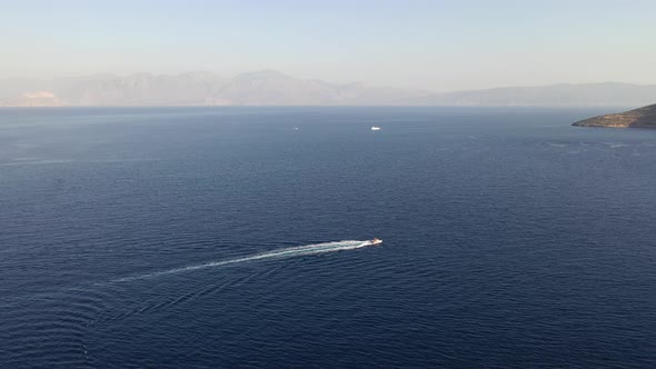 Aerial View of a Motor Boat Towing a Water Skier. Elounda, Crete, Greece