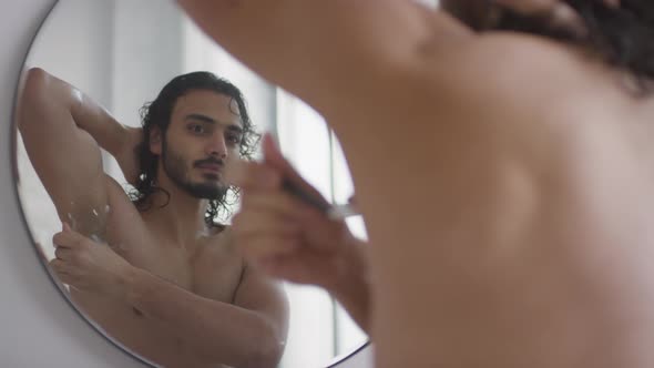 Attractive Man Shaving His Armpit in Bathroom alt
