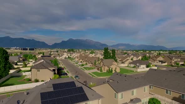 Aerial view of a suburban neighborhood with nice houses some with solar panels alt
