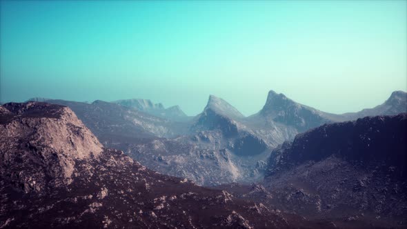 Silhouette of Swiss Alps Mountains in Morning Clouds alt