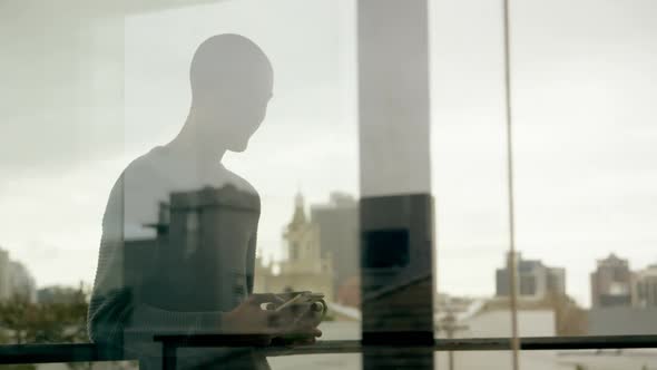 Man standing in balcony at home 4k alt