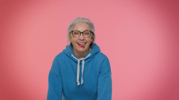 Mature Old Grandmother Woman Making Playful Silly Face Expressions Grimacing Fooling Showing Tongue alt