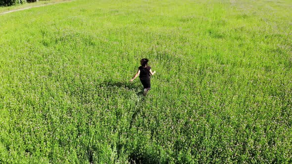 Happy Woman Running By Green Field, Happiness Freedom Inspirational Concept, Shot From Drone Above