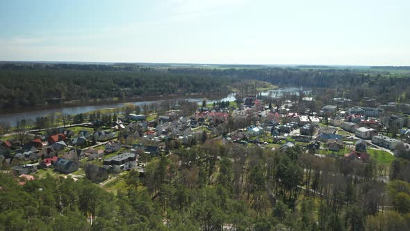 AERIAL: Birstonas Town on Sunny Spring Day with Nemunas River in Background