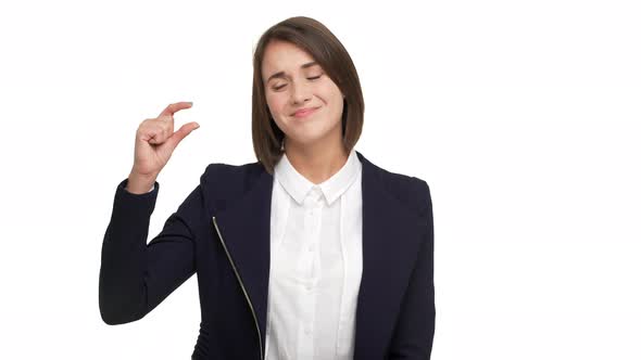 Portrait of Skeptically Smiling Woman 30s Wearing in Casual Doing Size Gesture with Fingers alt