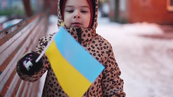 Ukrainian Kid Outdoors in Poltava Ukraine with Flag of the Country alt