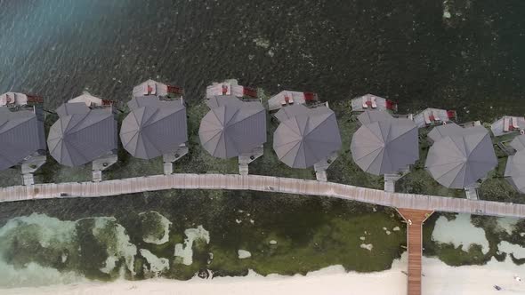 Aerial view of beach and harbor of a luxury resort, Maldives island. alt