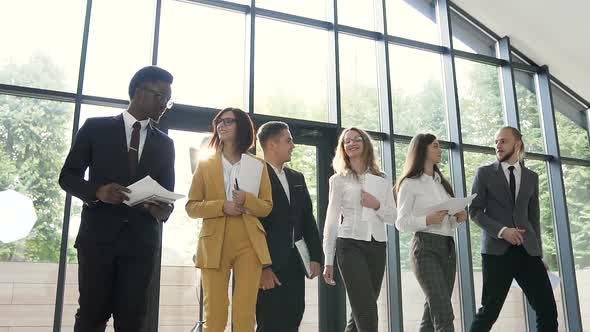 group of young multiethnic business people going to conference at the modern office alt