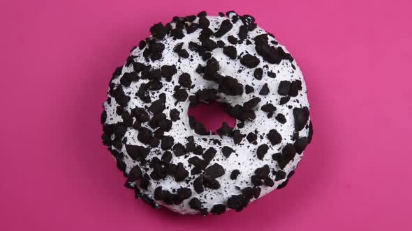 Donut with White Icing on an Pink Background