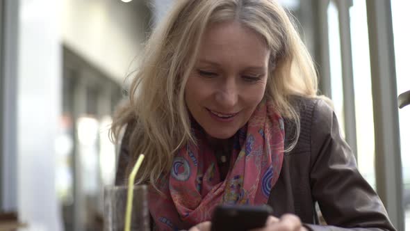 Woman text messaging on smart phone