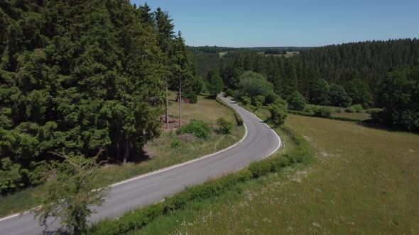 Road in nature reserve Eifel in Germany near Kalterherberg, hills and forest alt